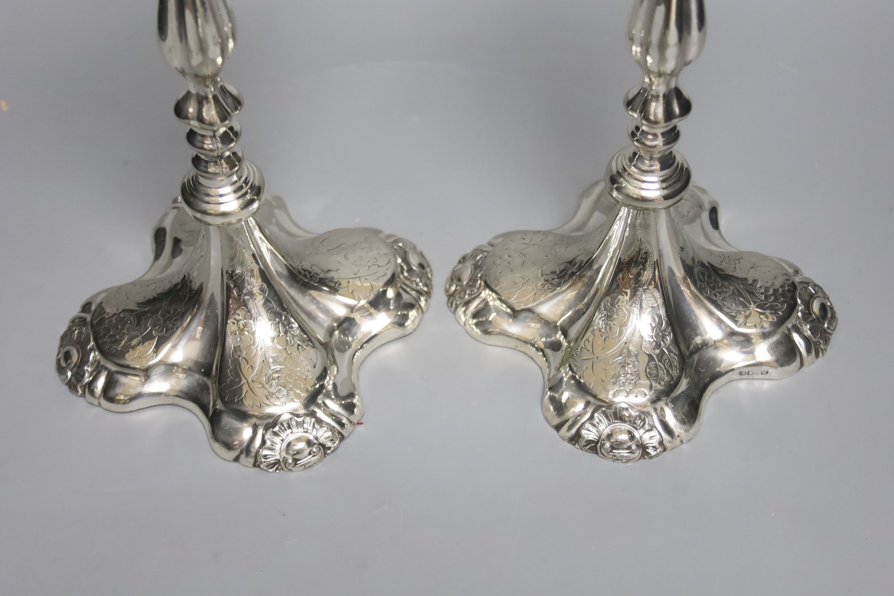 A pair of plated candlesticks, height 26cm